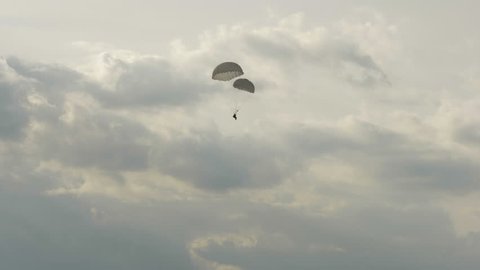 Paratrooper landing with two parachutes - slowmotion 60fps