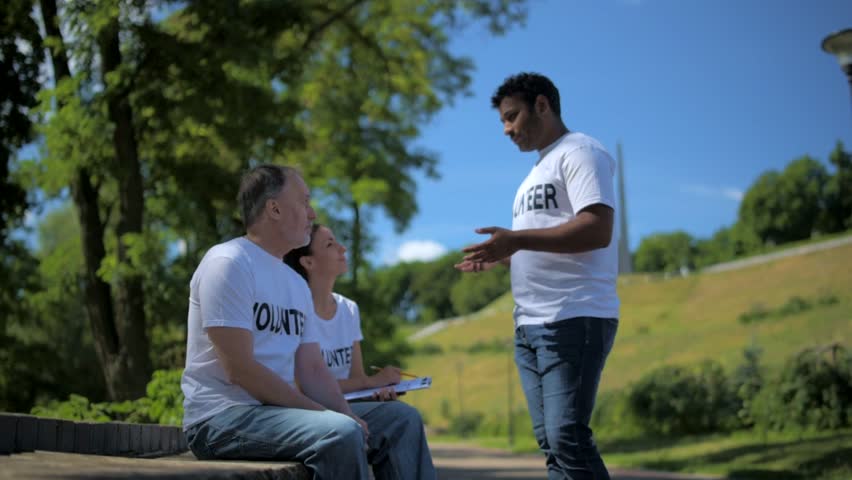 Enthusiastic volunteers sitting in the park
