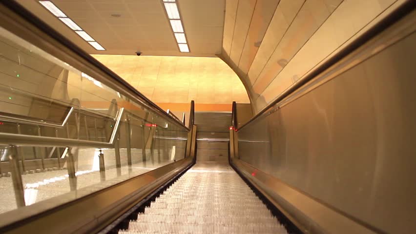 Istanbul city subway station steps to metro platform. Descending escalators and