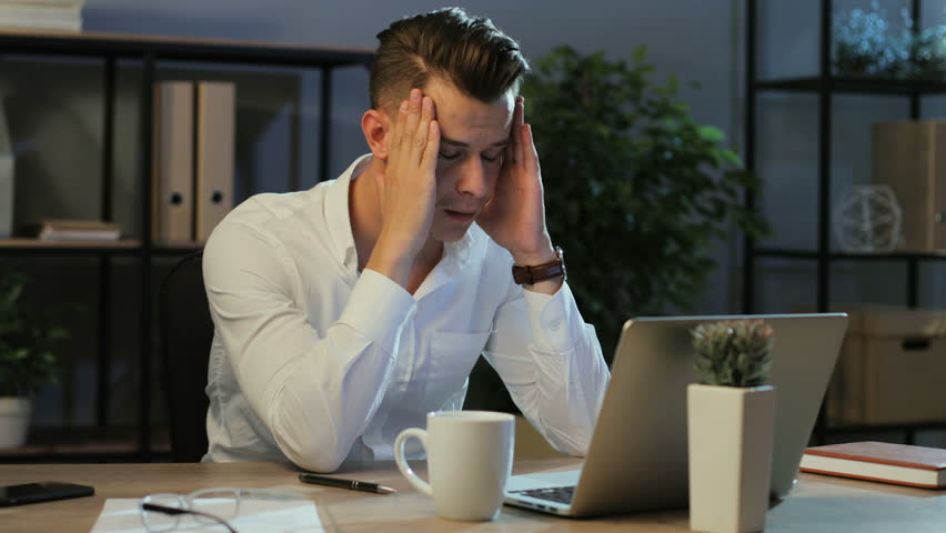 Portrait of young business man in casual shirt try working with anoying head ache in the laptop in the stylish office. | Shutterstock HD Video #29706814