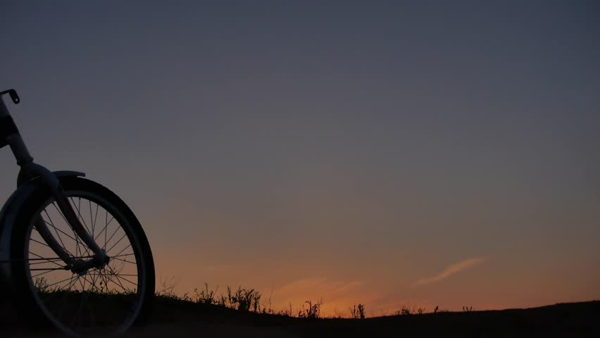 The boy teen and man is riding a bicycle. Travel silhouette sunset sunrise sunlight traveler