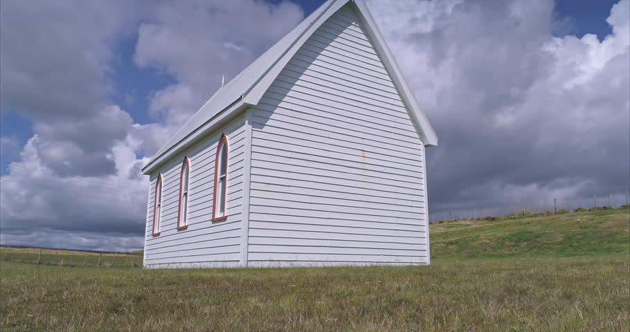 Aerial: Small historic pioneer church in Awhitu penninsula, Auckland New Zealand