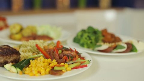 Appetizing, colorful and tasty food. Garnish salad and meat for every day of the week. Presentation of the lunch menu.