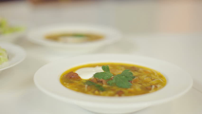 Presentation of restaurant lunch menu. Meat soup and light salad from cabbage