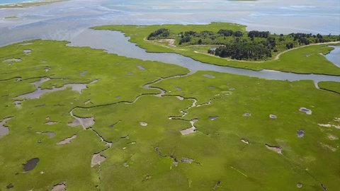 Aerial footage of channels winding through a marsh in Pleasant Bay, Cape Cod. Marshes and wetlands provide flood and erosion control and furnish food and homes for fish, birds and other wildlife.