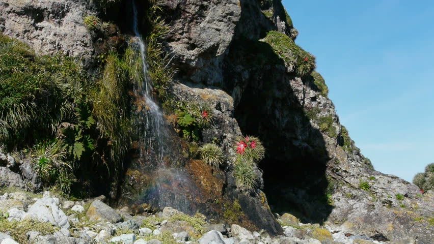 Slow-motion of colorful waterfall in Chiloe, Chile