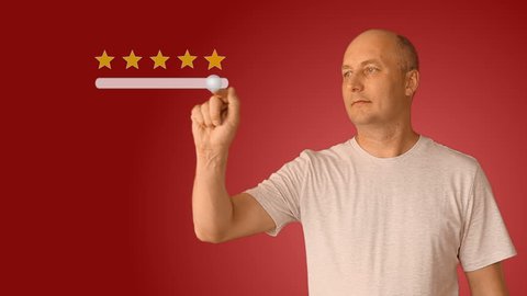 Feedback five stars from man on virtual screen. Young man move slider to set rating of services from one to five star. Caucasian man smiling and show thumbs up.