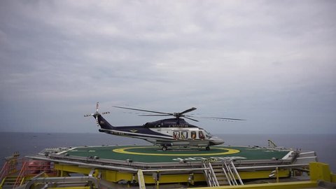 KELANTAN, MALAYSIA - JUNE 12 2017 : A commercial helicopter, Agusta Westland AW139 model ready for take off after picking up offshore passengers on oil and gas platform at South China Sea.