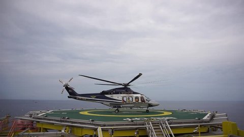 KELANTAN, MALAYSIA - JUNE 12 2017 : A commercial helicopter, Agusta Westland AW139 model depart after picking up offshore passengers on oil and gas platform at South China Sea.