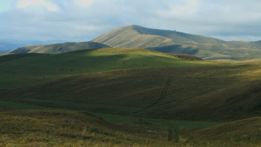 Green field with haystacks time lapse