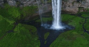 Aerial drone footage of waterfall Seljalandsfoss on Iceland in Icelandic nature. Famous tourist attractions and landmarks destinations in Icelandic nature landscape on the ring road, South Iceland.