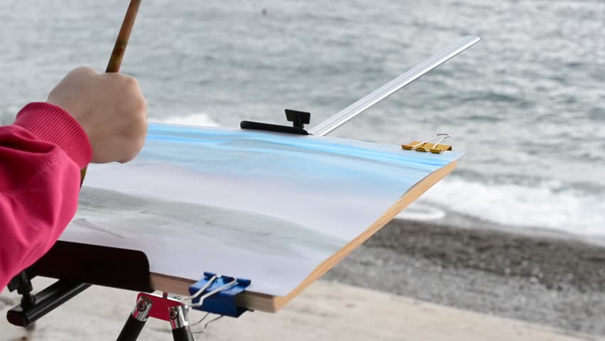 Water color, the child draws the sea.