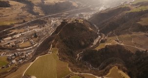 Aerial shot, a small perched town Chiusa in Italy, Sud Tirol, in the middle of the vineyards, 4K