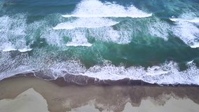 Beautiful aerial view footage of frothy wave on Parangtritis beach in Yogyakarta, Indonesia. Shot in 4k resolution
