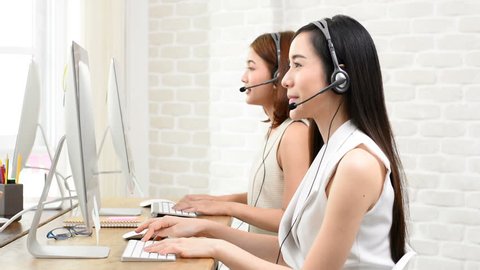 Asian telemarketing customer service agent team working in the office, call center job concept