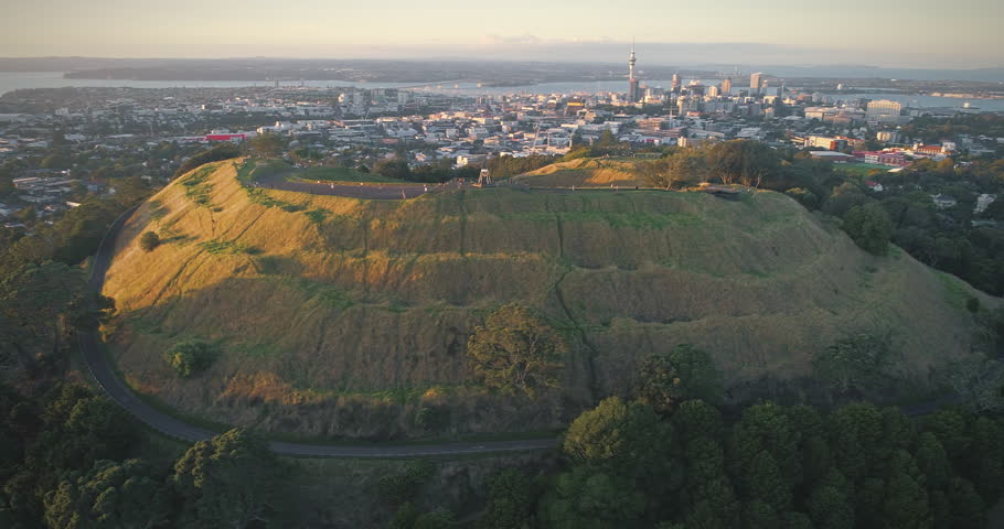 Aerial Over Mt Eden Volcano, city skyline at sunset In Auckland, New Zealand