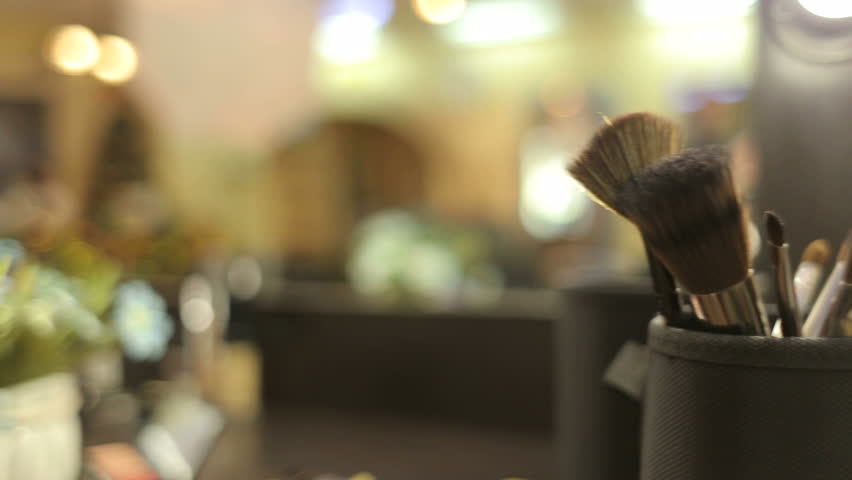 Set of brushes for make-up on table in dressing room. Close-up of professional cosmetics make-up brushes.