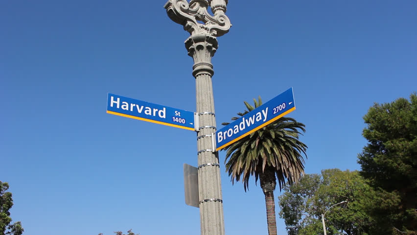 Low angle of street signs at the  intersection of Harvard and Broadway in Santa Monica California USA