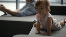 Cute toddler crawling on the sofa