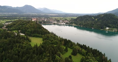 AERIAL view. flying over  Bled Lake and Castle . Beautiful  panoramic landscape with Alps mountains in the backgound , Slovenia .
