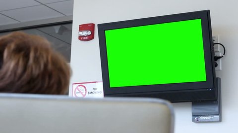 Woman watching green screen TV in nursing home or hospital