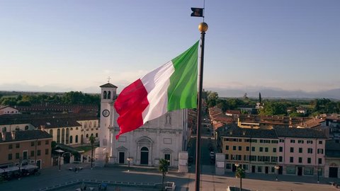 PALMANOVA, ITALY - AUGUST 9, 2017. Aerial view of waving Italian flag in the central square of the town