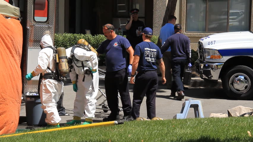 MISSISSAUGA, CANADA - JULY 1 2012: Police in hazardous materials suits working