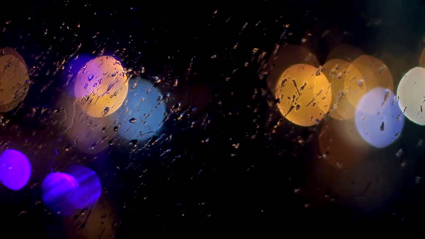 Night traffic lights through window with raindrops. Colorful light reflections on a glass in the rain at night.  | Shutterstock HD Video #29770615