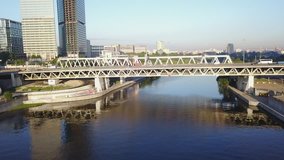 4K aerial view drone video of Moscow City area, International business centre, Moscow River with bridge, skyscrapers and boats along the river in Russia on sunny summer morning
