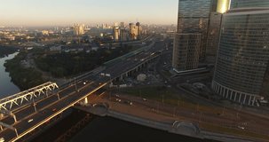 4K aerial view drone video of Moscow City area, International business center, Moscow River with bridge, skyscrapers and boats along the river in Russia on calm quiet sunny summer August morning