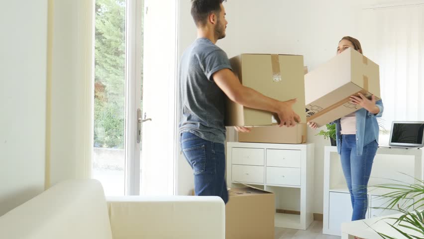 Happy young couple student roommate packing boxes and moving furniture during move into new home flat apartment | Shutterstock HD Video #29772694