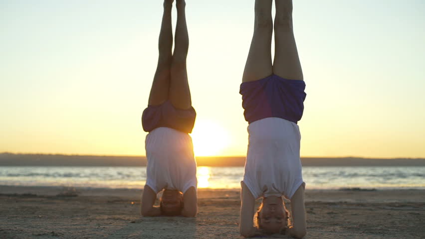 People support headstand yoga pose salamba sirshasanasunrise rapid slow motion  | Shutterstock HD Video #29777266