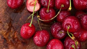 Fresh Cherries rotating on a wooden plate (not loopable; 4K)