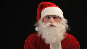 Close-up of Santa blowing snow, isolated against black background