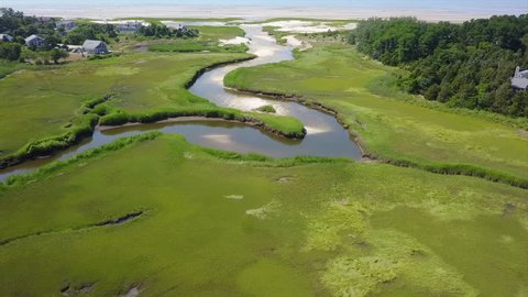 Aerial view of a channel winding through a marsh in Cape Cod, Massachusetts. Marshes and wetlands provide flood and erosion control and furnish food and homes for fish, birds and other wildlife.