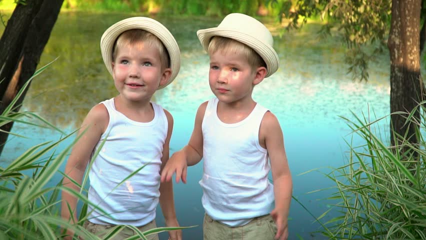 Brothers are whispered after fishing. happy children after fishing.