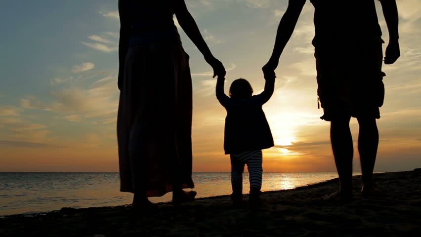 Happy family walking on sea coast. Silhouettes sunset. Royalty-Free Stock Footage #2980051