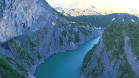 Blue mountain lake with rope bridge near Grenoble, France 