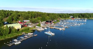 SKALDO, UUSIMAA, FINLAND - JULY 29: Cinema 4k aerial view around sommarostrand harbor, in the finnish archipelago, on a sunny evening dawn, near Tammisaaren kansallispuisto
