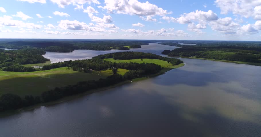 Land of thousand lakes, Cinema 4k aerial view above lohjanjarvi lake and lohjansaari island, on a sunny day, Lohja, Uusimaa, Finland.