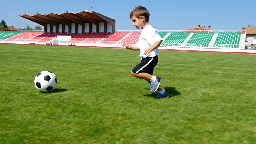 Tracking camera of a little 3 years old boy scoring a goal in a football field Royalty-Free Stock Footage #29805973