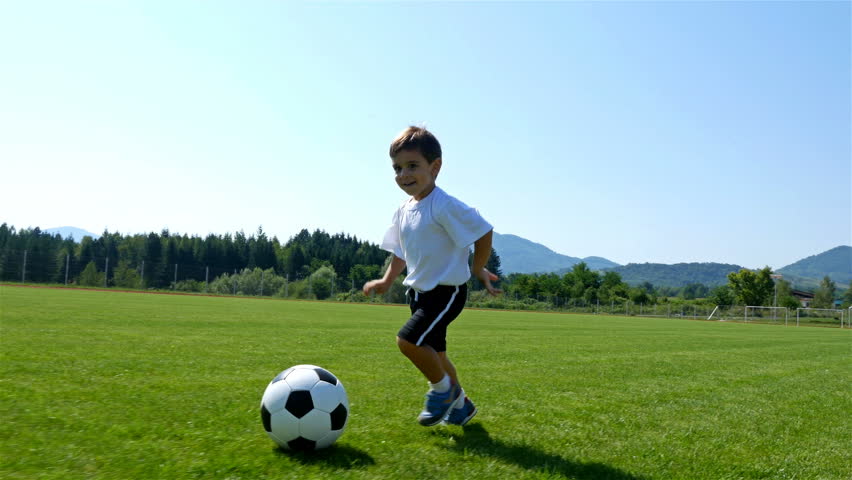 Tracking camera of a little 3 years old boy scoring a goal in a football field Royalty-Free Stock Footage #29805976