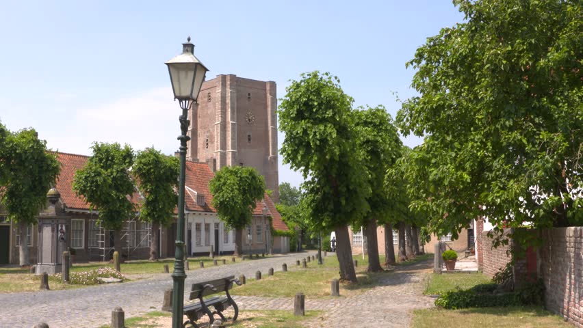 Village green with water pump of Sint Anna ter Muiden, a medieval town that was granted city rights in 1242, located on the westernmost point of the Netherlands in Zeelandic Flanders.