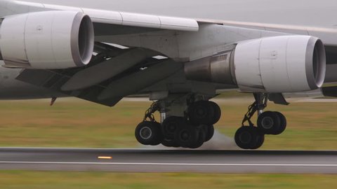 airplane jumbo jet 747 wheels touchdown runway slow motion