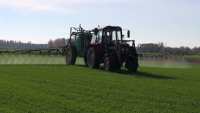 farm tractor spray autumn season green crop field