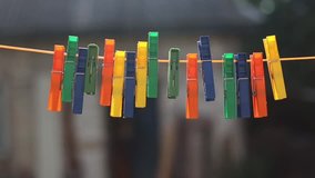 Abstract background with close up clothespins hanging on rope in wind. 
