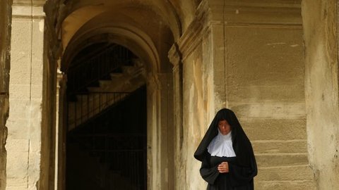 The ghost of a nun walks through the ruins of an old monastery. 4 k. Slow-motion shooting
