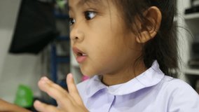 Asian Kindergarten children are  interested in using the internet on computer. Video for internet and technology concept