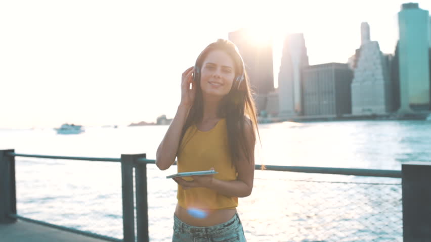Young Beautiful Woman Listening Music in New York City US