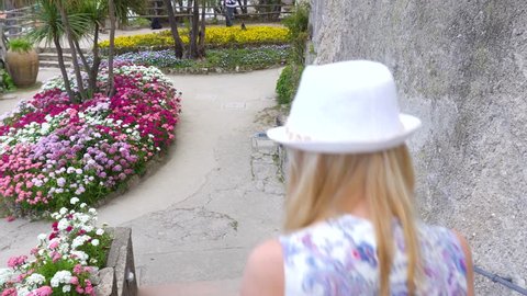 young blonde woman walking in Ravello, Italy